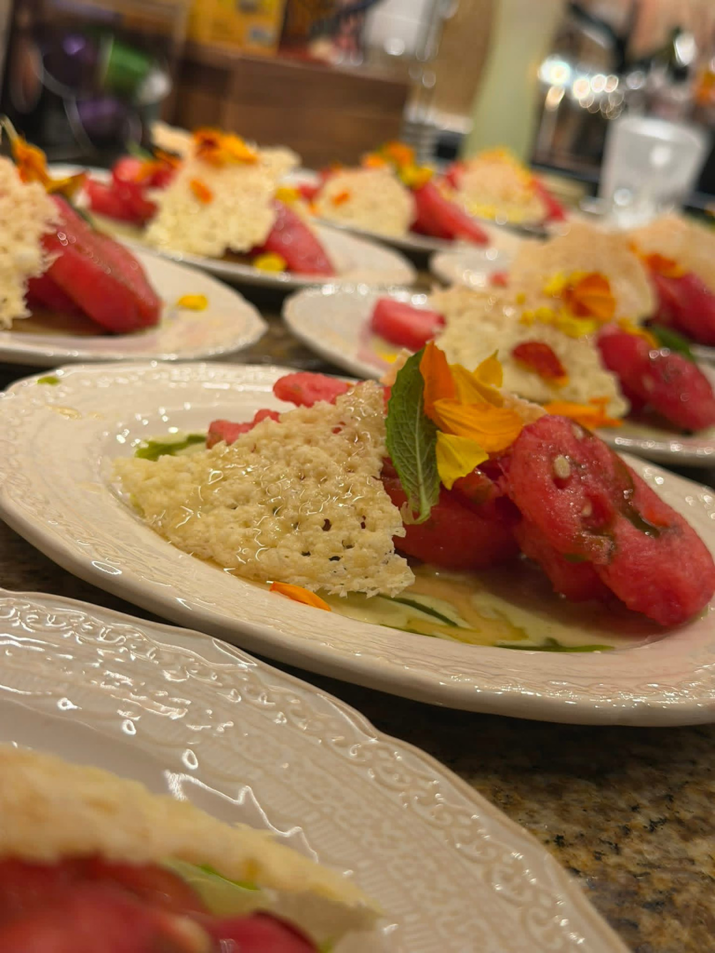 Plated courses lined up and ready for wedding service