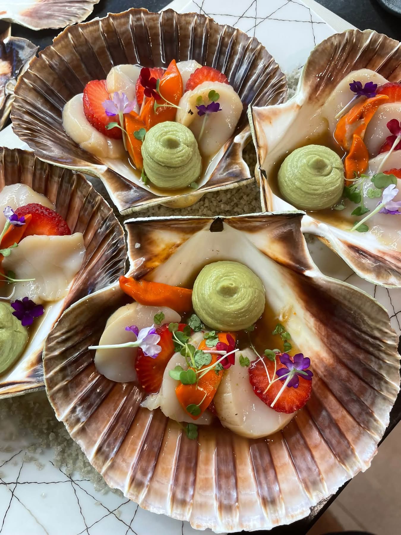 Scallops and strawberries served in the shell